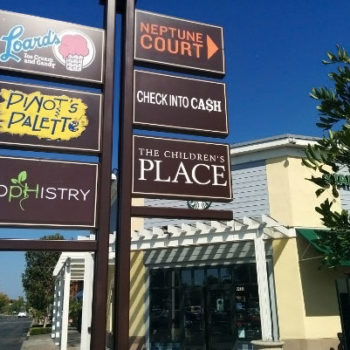 Outdoor signage for shops in shopping center.