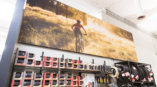 Large canvas with a women riding her bike in the woods. 