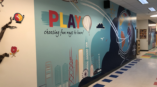 School wall graphic encouraging play. 